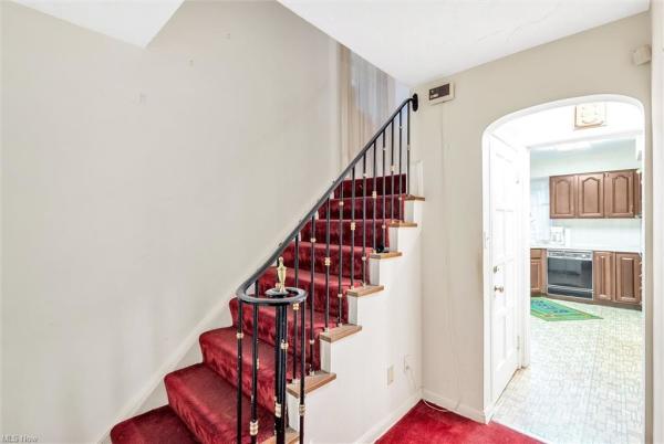 Stairway with wine-colored carpeting in Cleveland, Ohio house for sale, listed by Will Davis, Ohio probate specialist and realtor