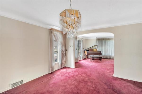 Dining room with opening leading to living room with piano in Cleveland, Ohio house for sale, listed by Will Davis, Ohio probate specialist and realtor