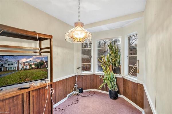 Nook with entertainment center, TV, and plants resting by bay &amp; bow windows in Cleveland, Ohio house for sale, listed by Will Davis, Ohio probate specialist and realtor