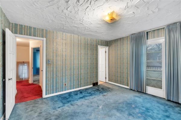 Bedroom with aqua blue carpet, blue green wallpaper, and blue green curtains in Cleveland, Ohio house for sale, listed by Will Davis, Ohio probate specialist and realtor